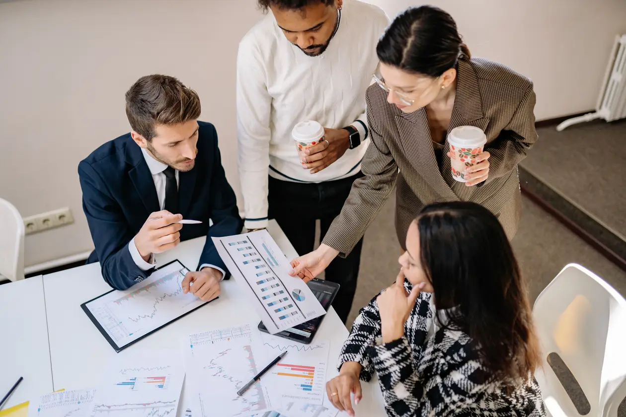 Businesspeople discussing data and strategy in an office setting